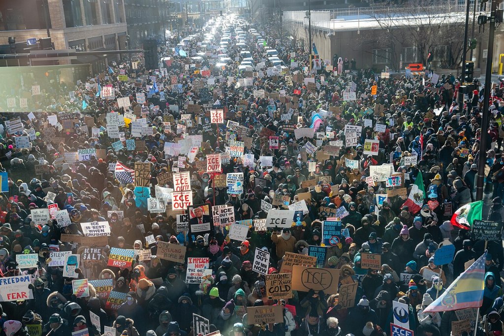 Arial shot of a crowd of anti-ICE demonstrators as far as the eye can see in downtown Minneapolis